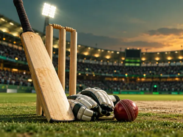 98s + Cricket bat, red ball, gloves and stumps beside a floodlit pitch